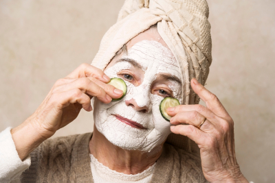 Elderly woman takes care of appearance
