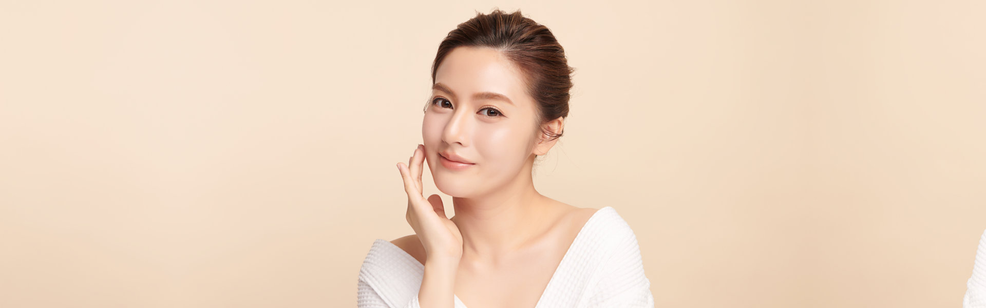 Beautiful young asian woman with clean fresh skin on beige background